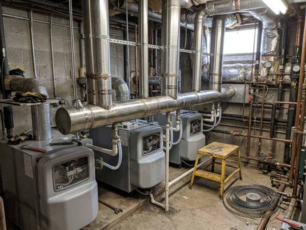 Common venting header connecting multiple commercial condensing boilers
