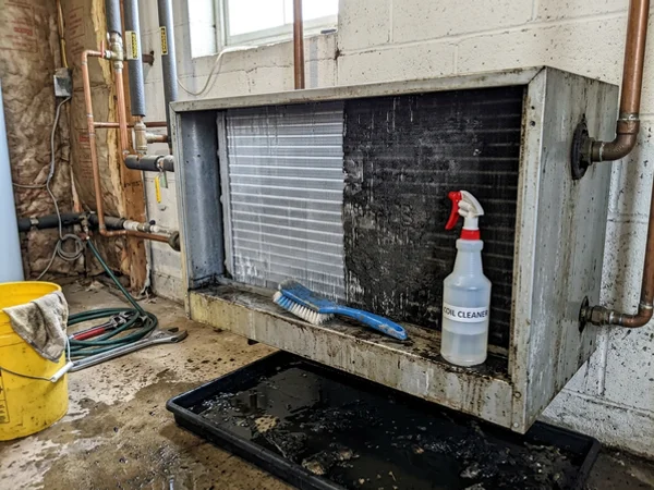 Heat exchanger fins part way through a wash showing cleaned and fouled sections