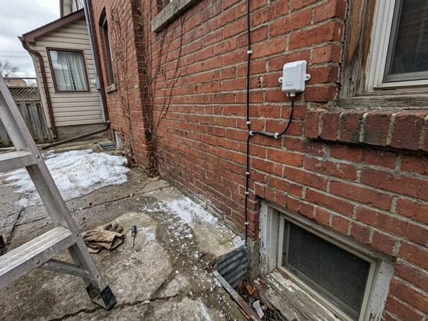 Outdoor reset sensor mounted on a north-facing Toronto exterior wall